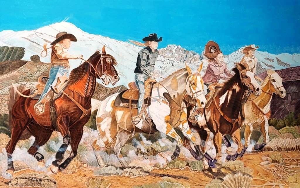 Four female riders racing near mountains